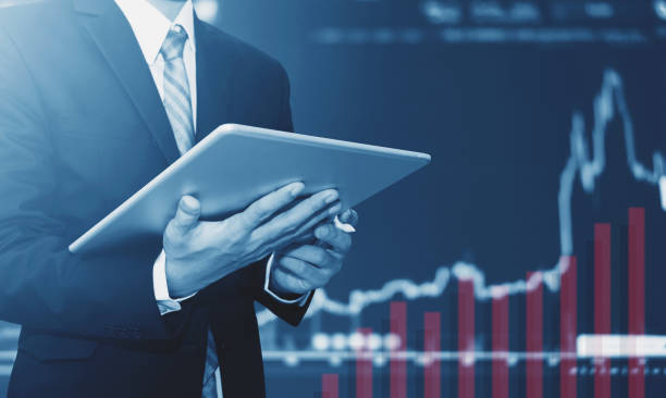 istock Businessman using digital tablet, raising graph background. Business growth, investment and invest in stock exchange market 877267146