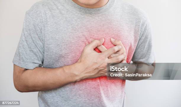 A Man Touching His Heart With Red Highlight Of Heart Attack Heart Failure And Others Heart Disease Stock Photo - Download Image Now