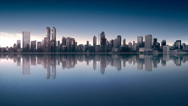 Downtown Indianapolis skyline during sunset / dusk with the sunset reflection on building windows, with White River and a mirror-like reflection of the skyline in the foreground.
