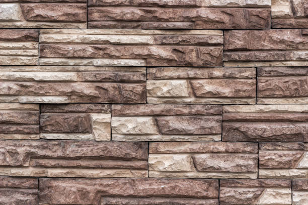 istock Imitation of brick masonry from artificial torn stone. 877274374