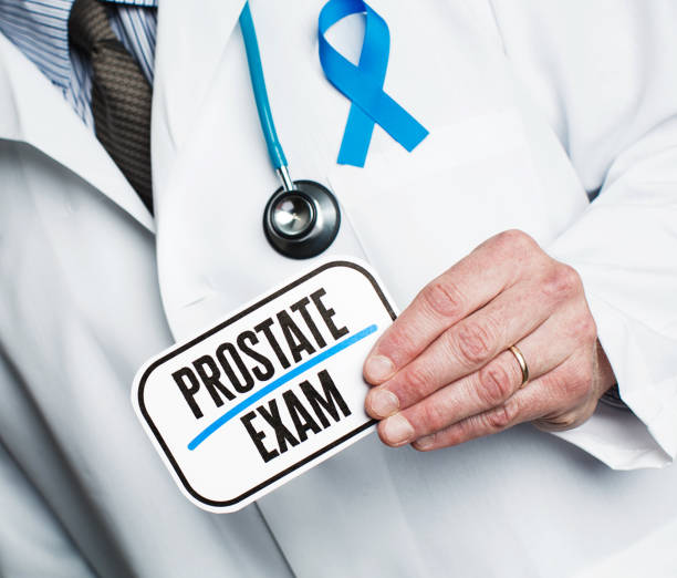 istock Doctor with stethoscope in white lab coat holding sign reading prostate exam 877277194