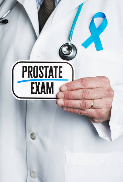 istock Doctor with stethoscope in white lab coat holding sign reading prostate exam 877277238