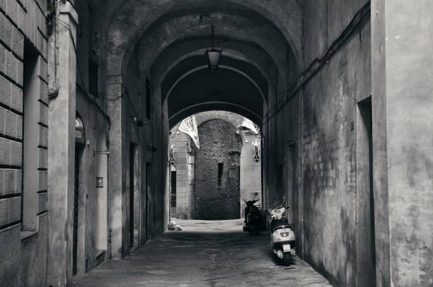Street view with old buildings and archway in Siena, Italy.