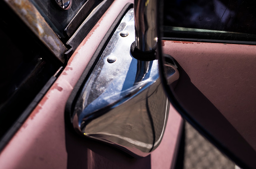 A side mirror of a car on a fine day.