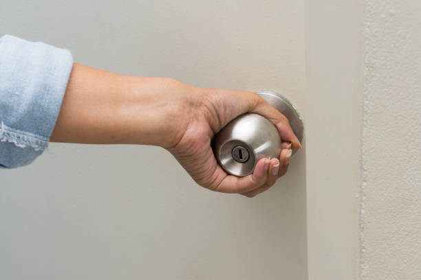 istock Asian women hand open door knob 877294462