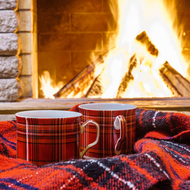 istock A cup of  tea,  wool things near cozy fireplace. 877294648