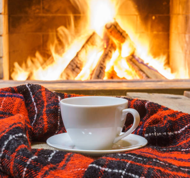 istock A cup of  tea,  wool things near cozy fireplace. 877294650