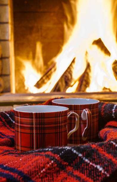 istock A cup of  tea,  wool things near cozy fireplace. 877294652