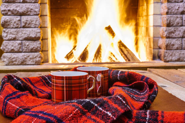 istock A cup of  tea,  wool things near cozy fireplace. 877294654