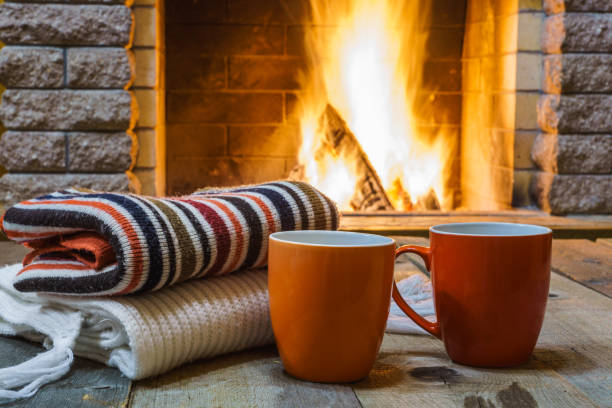 istock A cup of  tea,  wool things near cozy fireplace. 877294674