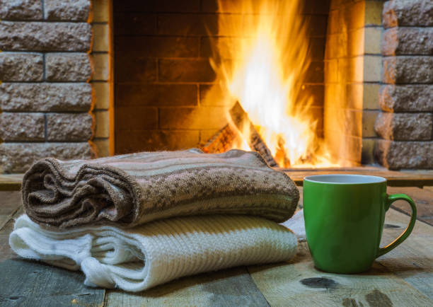 istock A cup of  tea,  wool things near cozy fireplace. 877294678