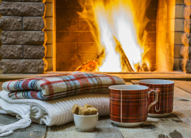 istock Two  cups of  tea,  wool  things near cozy fireplace. 877294680