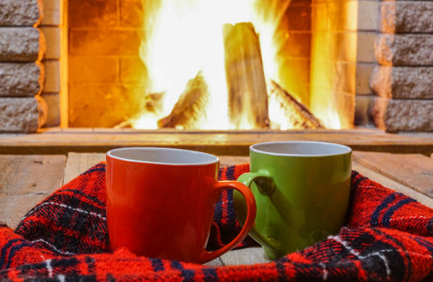istock A cup of  tea,  wool things near cozy fireplace. 877294696
