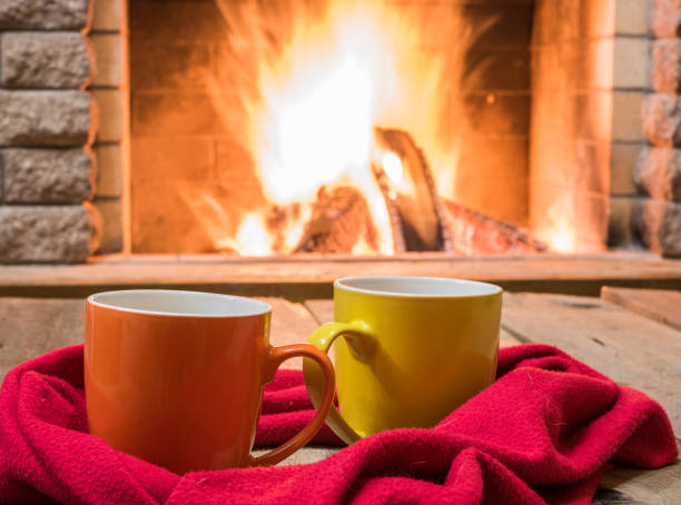 istock A cup of  tea,  wool things near cozy fireplace. 877294698