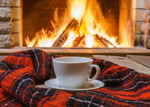 istock A cup of  tea,  wool things near cozy fireplace. 877294730