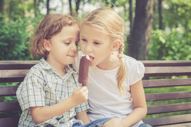 istock Two happy children  playing in park 877294892