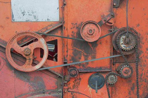 Mechanisms of an old combine harvester. Old technics. Gears, belts and chains