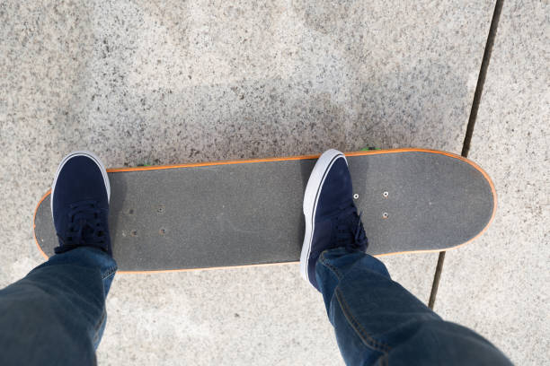 istock Skateboarder legs riding skateboard on city 877297926