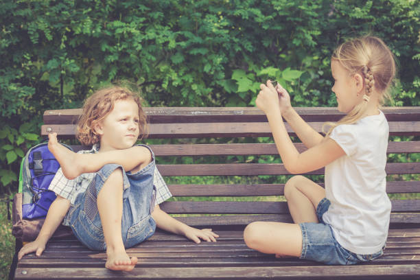 istock Two happy children  playing near the tree 877299996