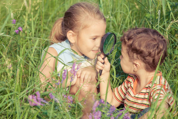 istock Two happy children  playing near the tree 877300118