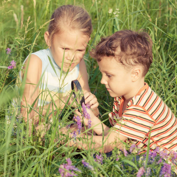 istock Two happy children  playing near the tree 877300130