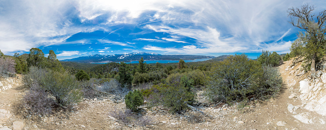 Wonderful panorama of lake Arrowhead taken on a long hiking excursion in mid day with some hazy and puffy clouds. Lake Arrowhead trail in Arrowhead California, near Big Bear