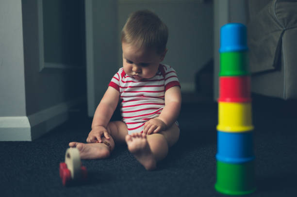 A Baby boy plays with toy blocks over white background
