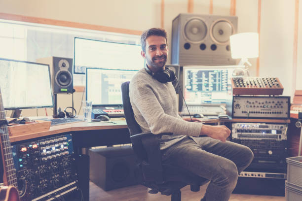 istock Confident man in sound recording studio 877305250