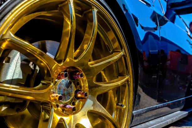 istock Golden rims on a black car looking very reflective 877307582