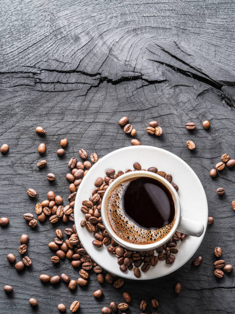 istock Cup of coffee surrounded by coffee beans. 877307662