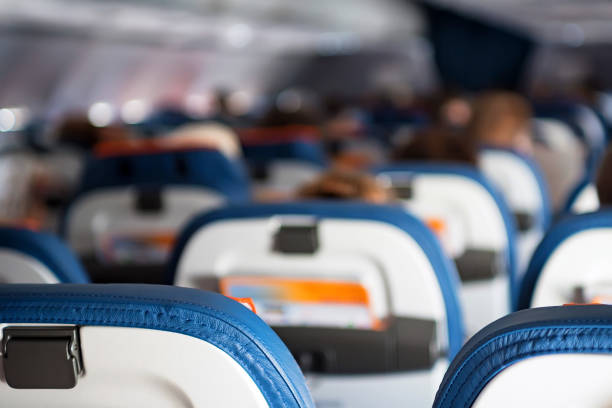 istock Close up passenger seats in cabin of plane 877309964