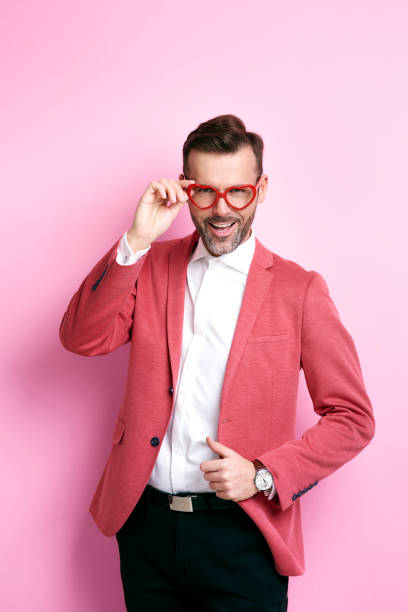 istock Cheerful man with heart shape eyeglasses posing 877313106