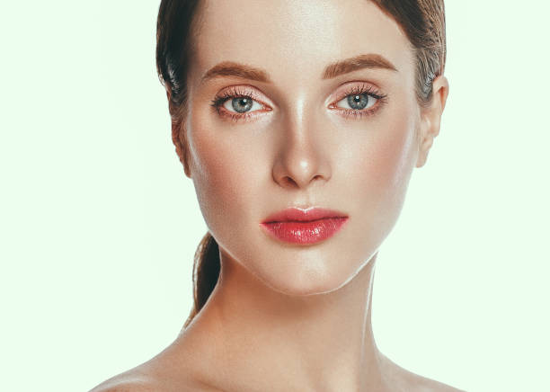 istock Beautiful woman face close up studio on white. 877313540