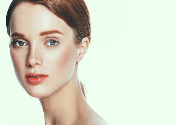 istock Beautiful woman face close up studio on white. 877316050