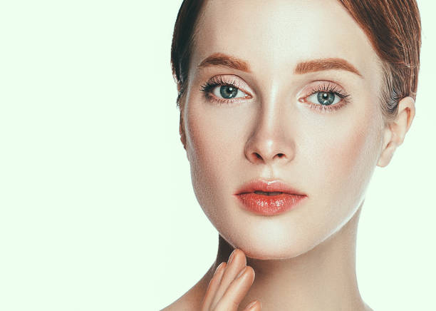 istock Beautiful woman face close up studio on white. 877316520