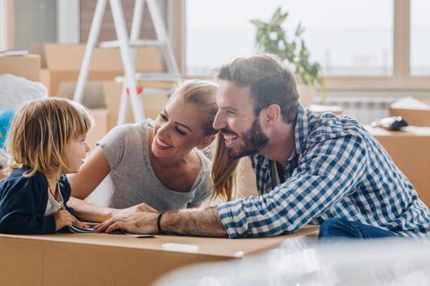 istock Happy parents talking to their son while moving into new home. 877316712