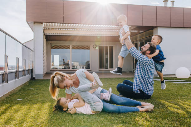 istock Carefree family having fun while playing on a penthouse balcony. 877317196