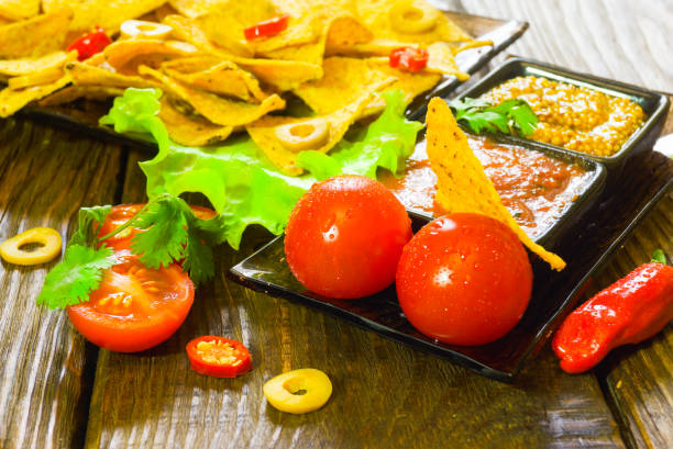istock Nachos  with Tortilla chips tomato salsa and mustard on rustic wooden background. A texture background.Copy paste place 877317642