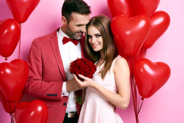 istock Man giving roses and embracing his girlfriend 877320066
