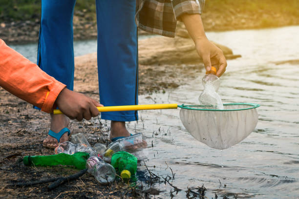 istock Group of kids volunteer help garbage collection charity environment. 877321314