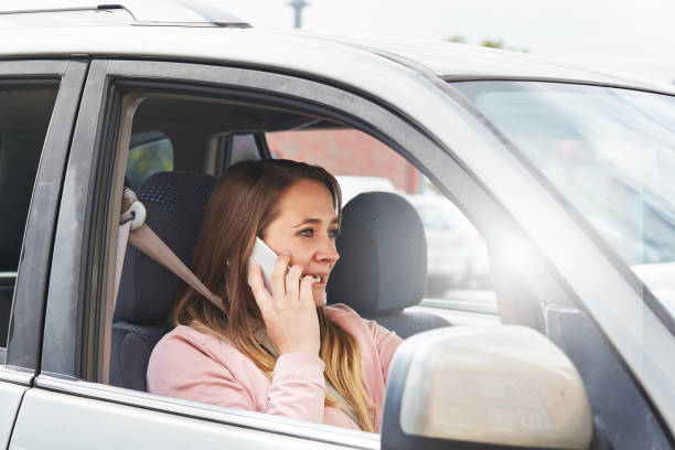 istock Woman driver chatting on mobile phone 877321352