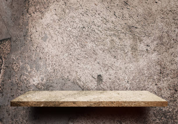 istock Empty display shelf on grungy dirt cement wall for product display 877324702