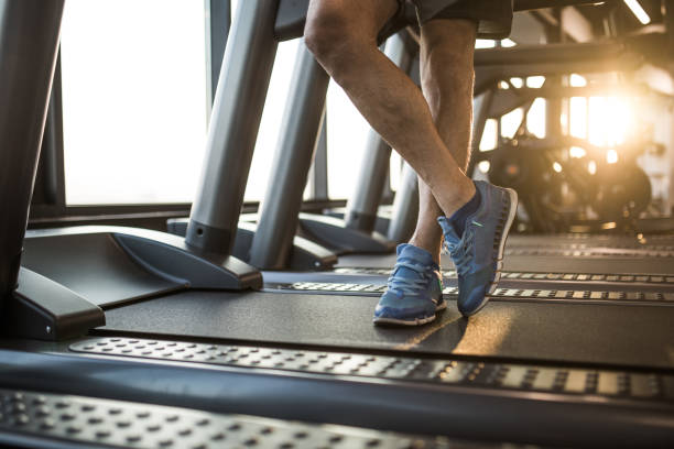 istock Unrecognizable male athlete standing on treadmill in a gym. 877324768