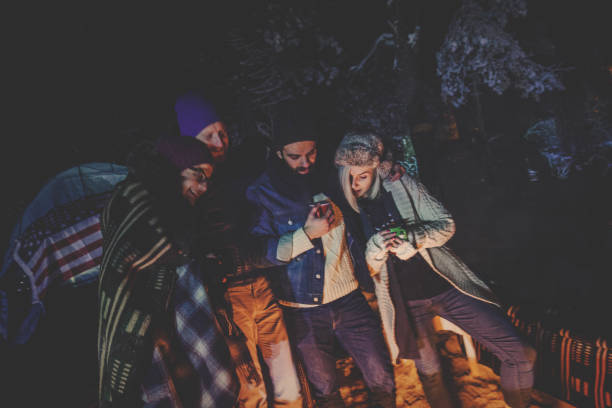 istock Hipster people camping on snowy mountain 877325024