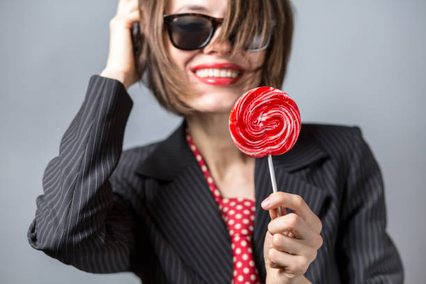 istock Beautiful young woman with lollipop 877325268