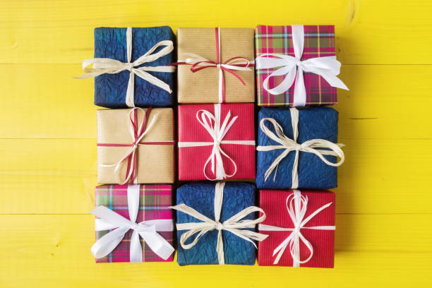 istock Number of various gift boxes on yellow wooden background 877326056