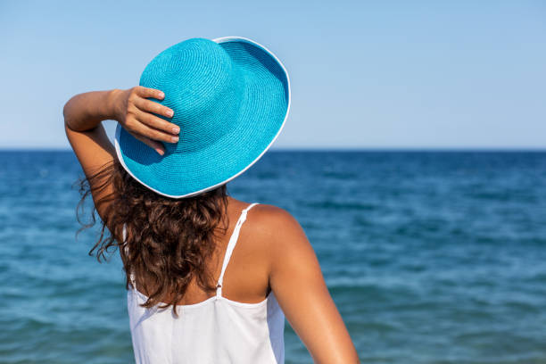 istock Woman relaxing at the seaside. 877329092