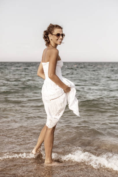 istock Woman relaxing at the seaside. 877329702