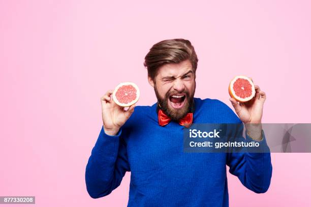 Screaming Man Holding Sour Fruit Stock Photo - Download Image Now - Sour Taste, Adult, Adults Only