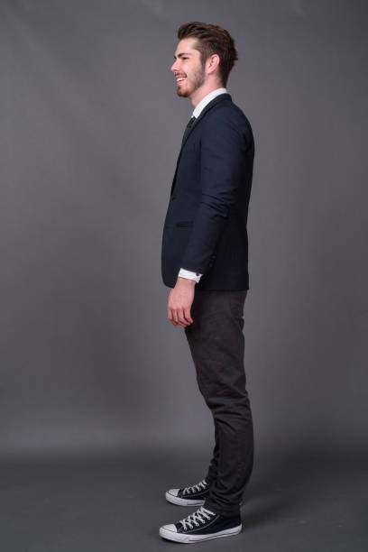 istock Young bearded handsome businessman against gray background 877330400